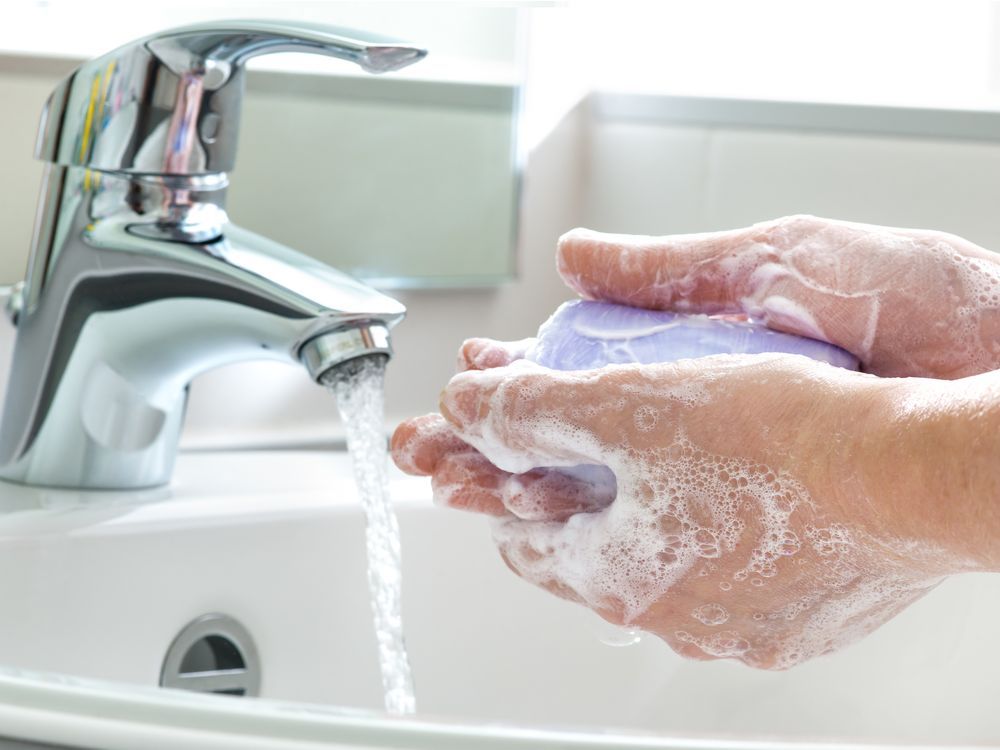 Stock photo of a person washing their hands.