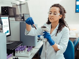 Scientist with a test tube fill of blood