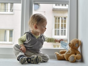 baby sitting with teddy bear
