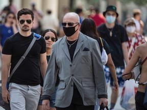 PANDEMIC?Some choose to wear masks and some do not at Toronto's Dundas Square during the Covid 19 pandemic, Monday July 6, 2020.