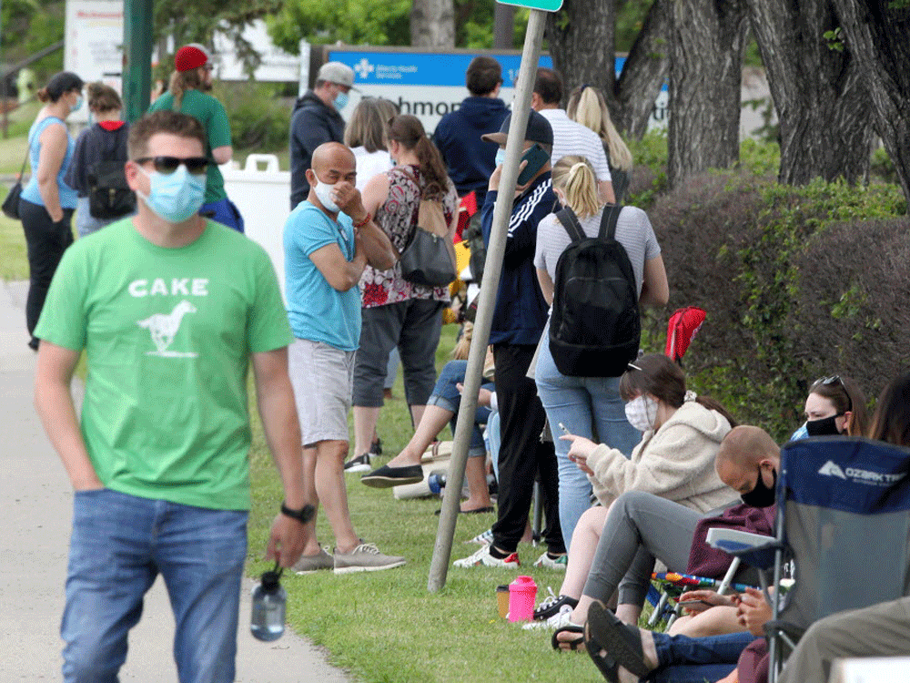 people wait in line at a covid-19 assessment centre in calgary. contact tracing when someone tests positive has become a bit of a holy grail in the fight against covid-19.