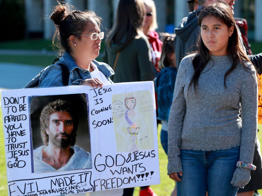 a small group of anti-mask protesters rally in front of ottawa city hall on aug. 26.