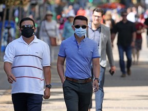 Calgarians wear masks as they walk along Stephen Avenue Mall in downtown Calgary on Wednesday, July 29, 2020.