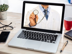 doctor on a laptop screen holding a stethoscope