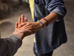man holding woman's hand