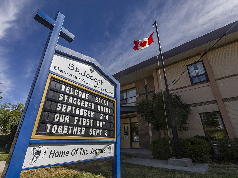 pictured is the reopening sign outside st. joseph elementary and junior high school on monday, august 31, 2020.