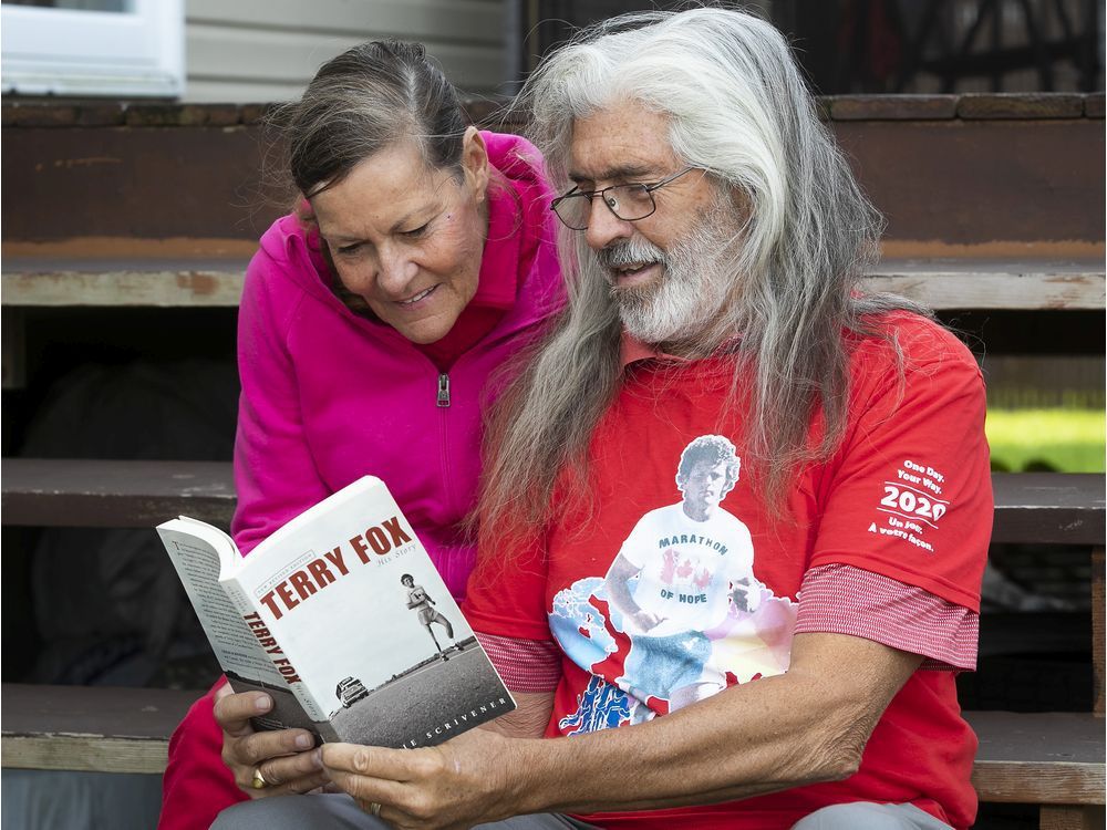 linda jette and husband les hay have a look at a book on terry fox who inspired canadians to raise funds for cancer research.