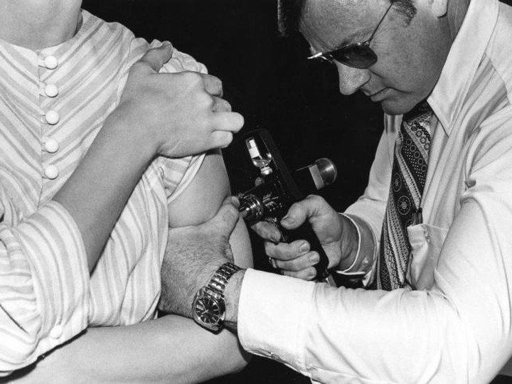  This 1976 photograph showed an adult receiving a vaccination with a jet injector during the swine flu nationwide vaccination campaign, which began October 1, 1976.