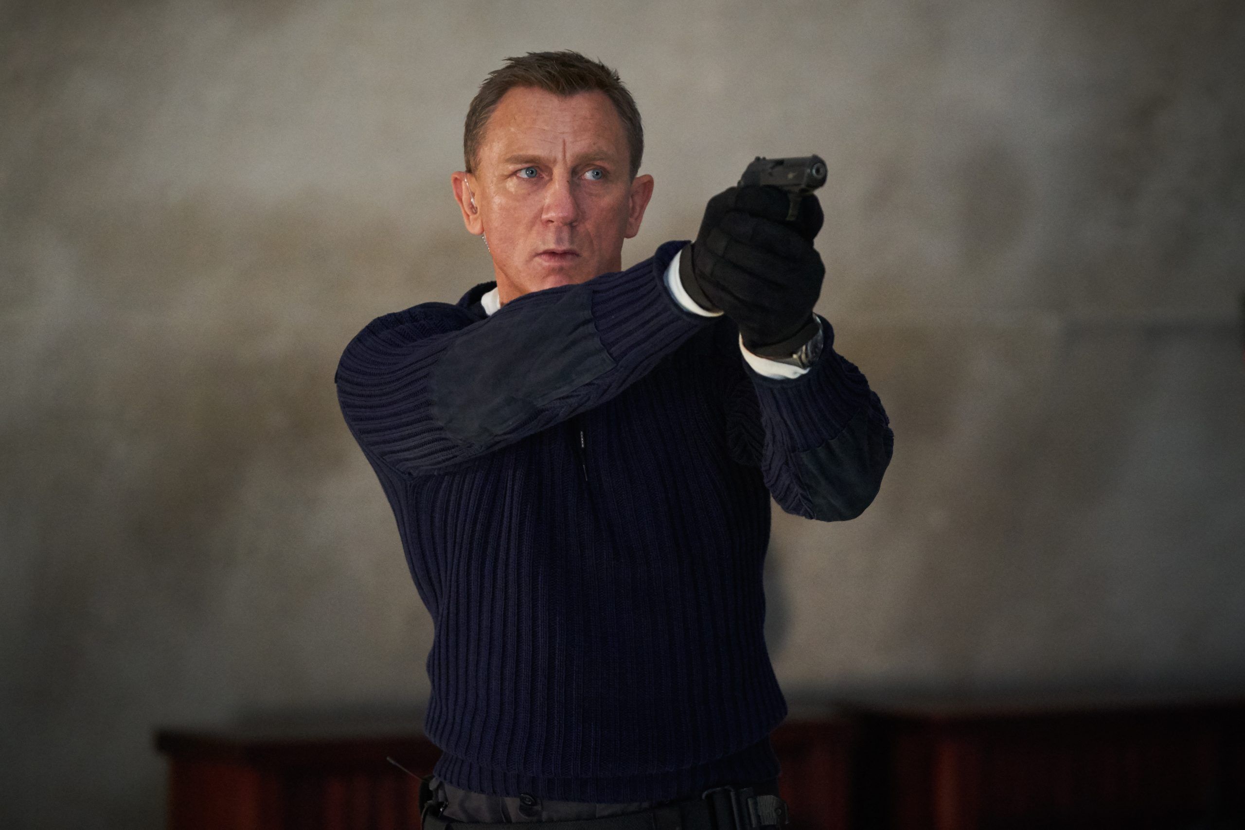 James Bond (Daniel Craig) prepares to shoot in No Time To Die, a DANJAQ and Metro Goldwyn Mayer Pictures film.