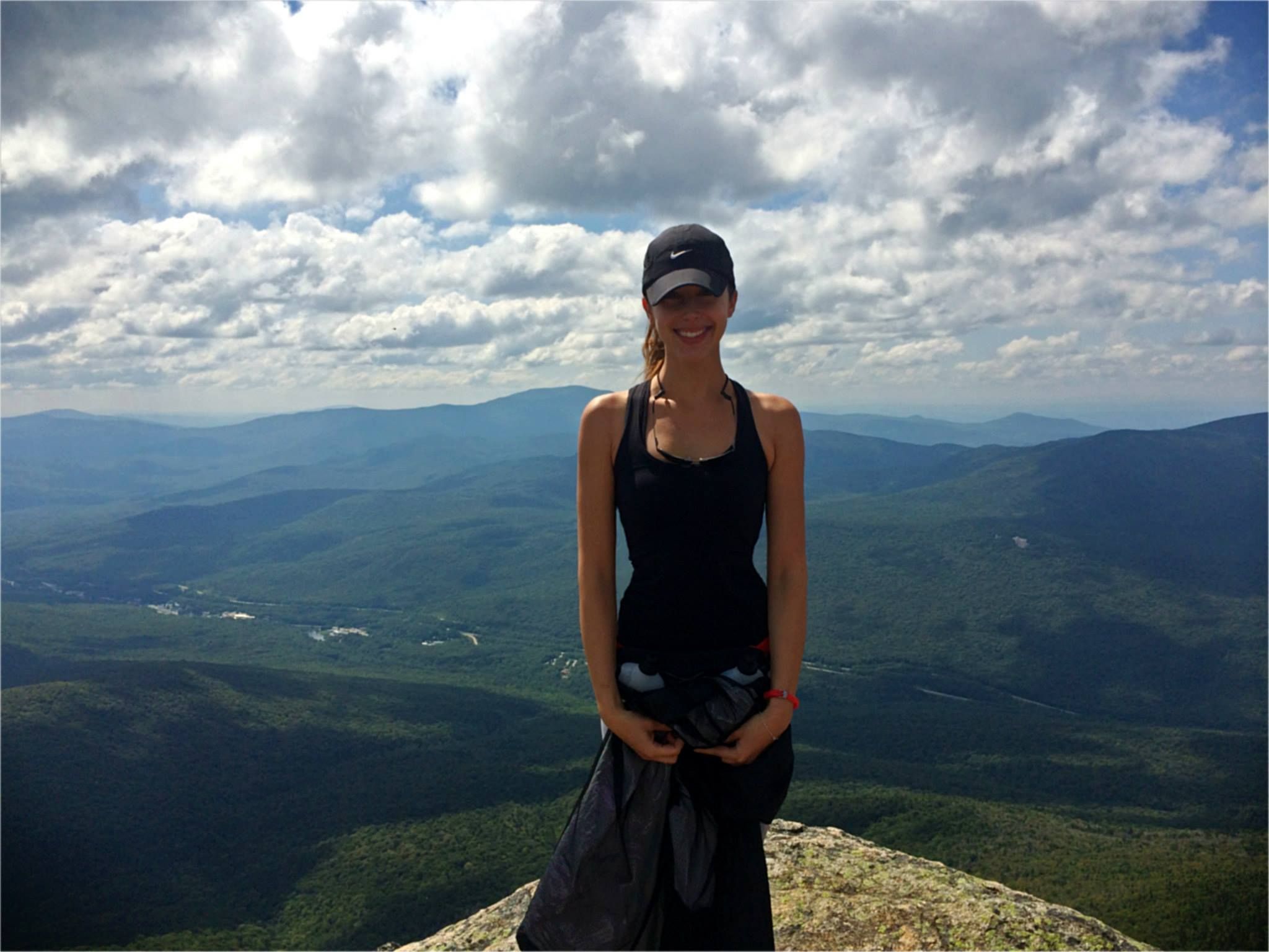 Lauren Nichols, a COVID-19 long-hauler, on top of a mountain