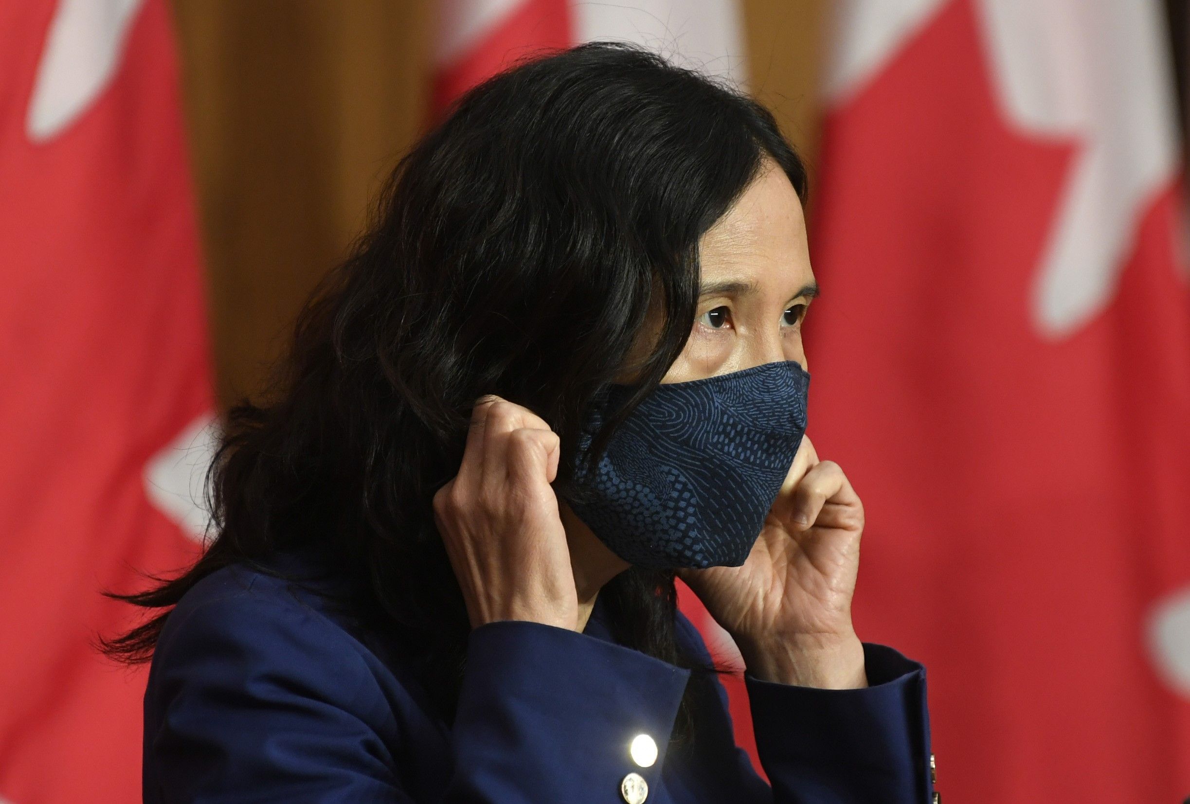 Chief Public Health Officer Theresa Tam removes her mask as she arrives for a news conference Friday, October 2, 2020 in Ottawa.  