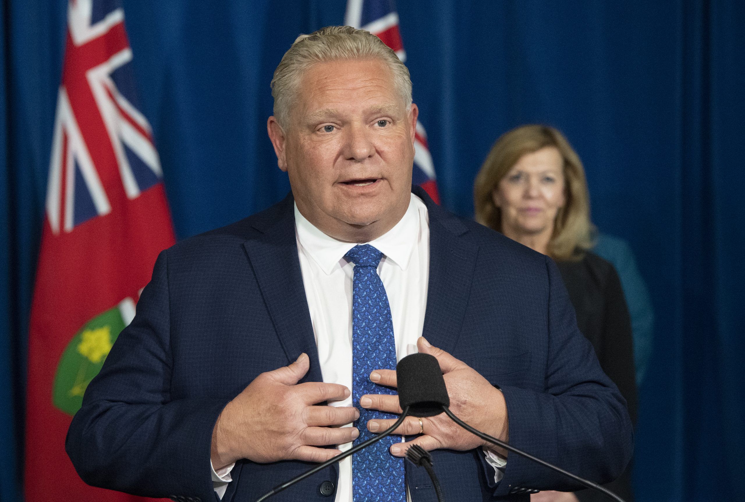 Ontario Premier Doug Ford answers questions during the daily briefing at Queen's Park in Toronto on Monday November 16, 2020 as Health Minister Christine Elliott listens.