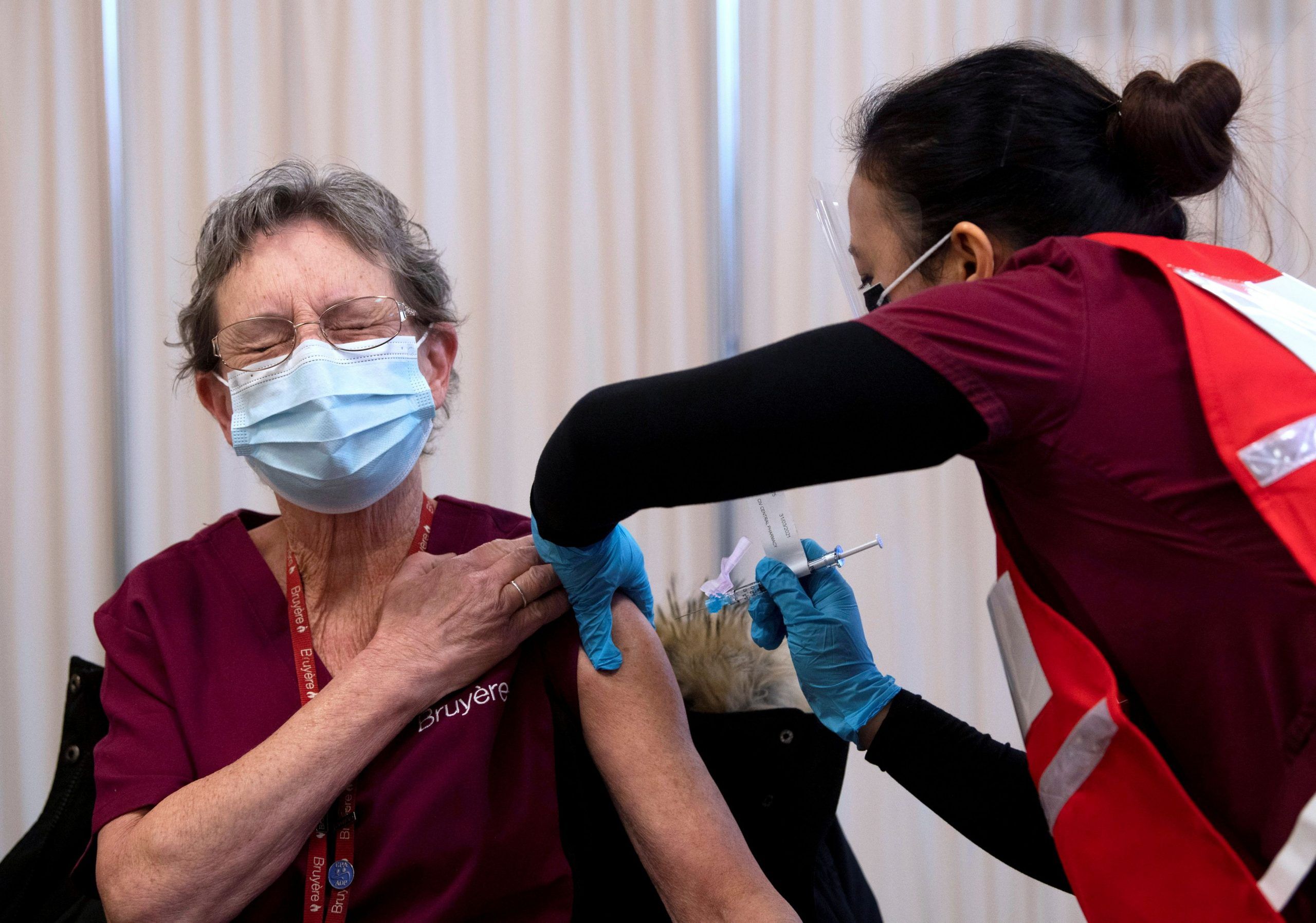 Personal support worker Johanne Lamesse reacts in anticipation to the needle as she receives the Pfizer-BioNTech COVID-19 vaccine at the Civic Hospital in Ottawa, Ontario, Canada December 15, 2020.   