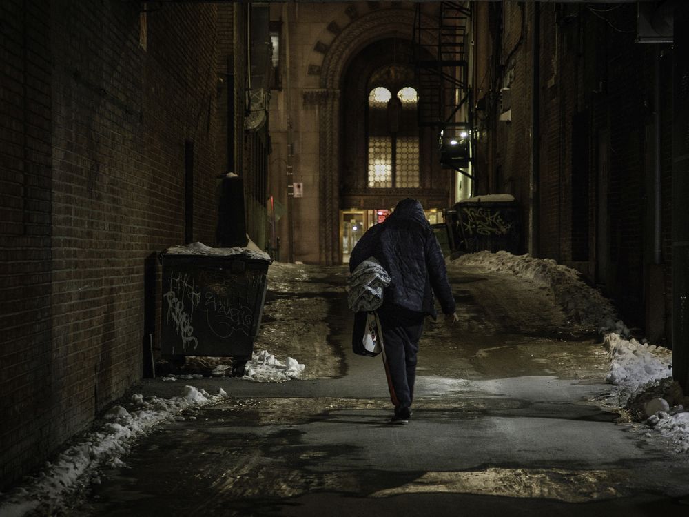 a homeless man walks in a lane near sainte-catherine st. at metcalfe st. on saturday, january 9, 2021 in montreal.