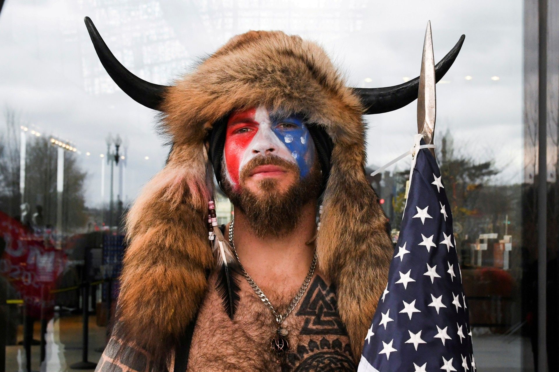 Jacob Anthony Chansley, also known as Jake Angeli, of Arizona, poses with his face painted in the colors of the U.S. flag as supporters of U.S. President Donald Trump gather in Washington, U.S. January 6, 2021. 