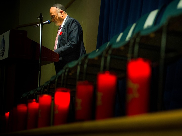  People gathered at the Soloway Jewish Community Centre Sunday October 28, 2018, for a vigil after the shooting in Pittsburgh this weekend that left 11 dead at a synagogue. Rabbi Reuven Bulka speaks to the crowd as he stands amongst the 11 chairs and candles for those who have passed.