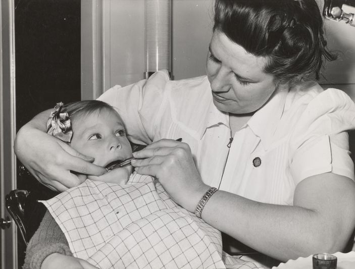 a fsa (farm security administration) nurse examines the teeth of migrant in the fsa dental trailer at the fsa camp for farm workers. caldwell, idaho, 1941.