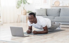 man in front of computer while exercising