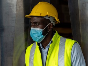 black construction worker wearing mask