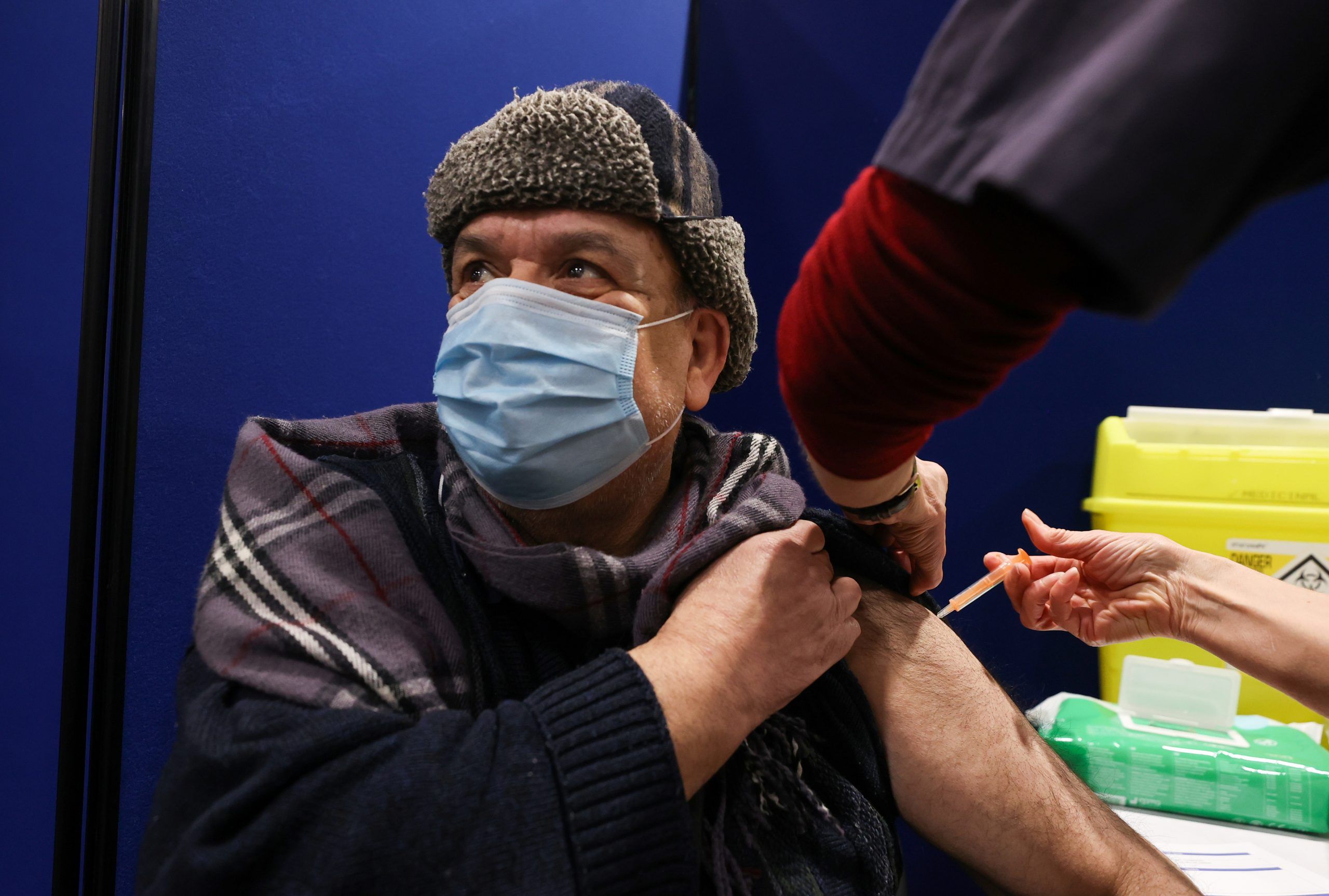 A man receives a dose of the AstraZeneca's coronavirus disease (COVID-19) vaccine, at the vaccination centre in the Newcastle Eagles Community Arena, in Newcastle upon Tyne, Britain, January 30, 2021.  