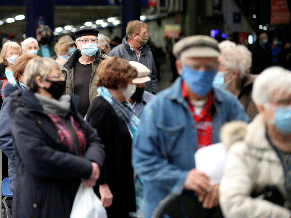 People wait in line at the Olympic Stadium in Montreal in early March for their COVID-19 jab as Quebec began vaccinations for seniors.