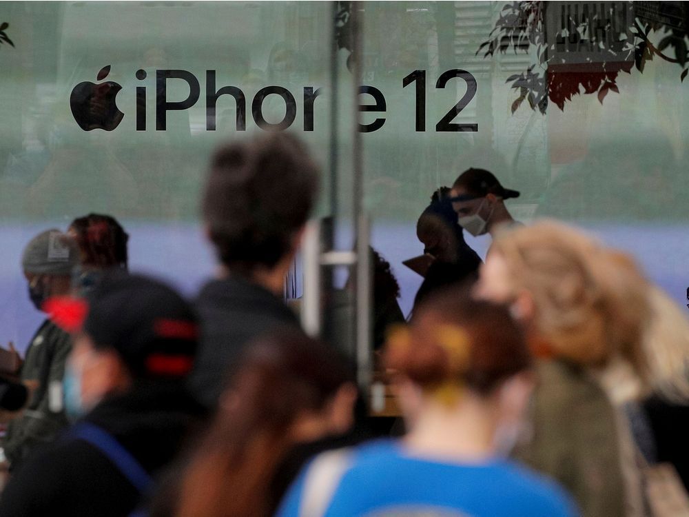 Customers wait in line outside an Apple Store to pick up Apple's new 5G iPhone 12 in Brooklyn, New York, U.S. October 23, 2020.