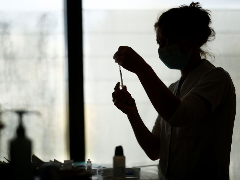 A healthcare worker prepares a dose of the Pfizer-BioNTech COVID-19 vaccine.