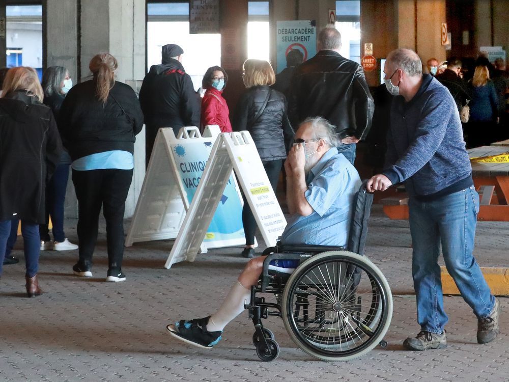 People over 55 line up for their COVID-19 vaccine outside the Palais Des Congres Thursday morning. In addition to taking thousands of appointments, there was also a lineup for walk-in vaccinations. Julie Oliver/POSTMEDIA