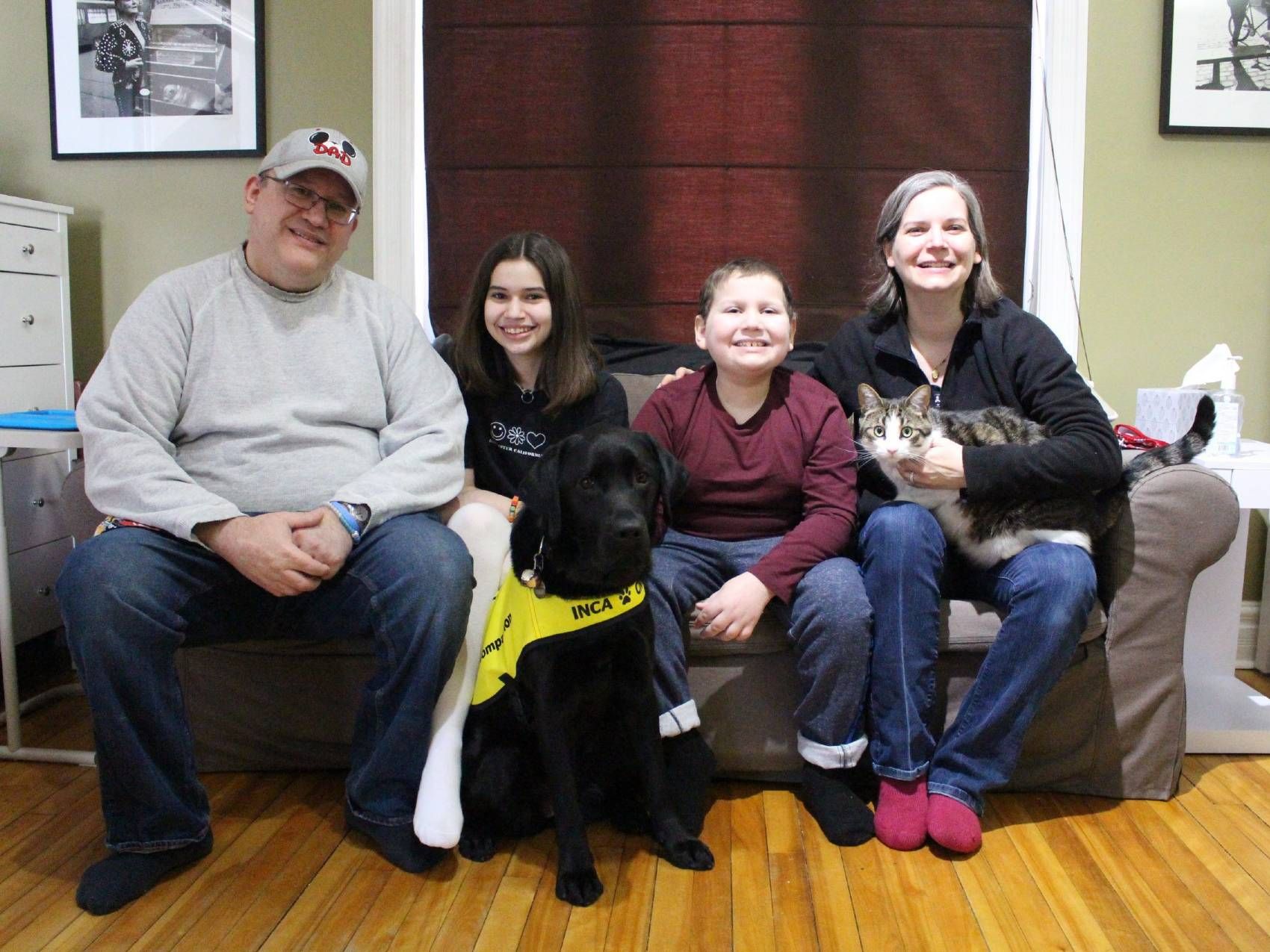 The Acosta-Pickering  family. From Left-right: Mario, Abby, Oliver, Dawn, and Chewbacca their cat. Oliver's dog, Hope, sits in front.