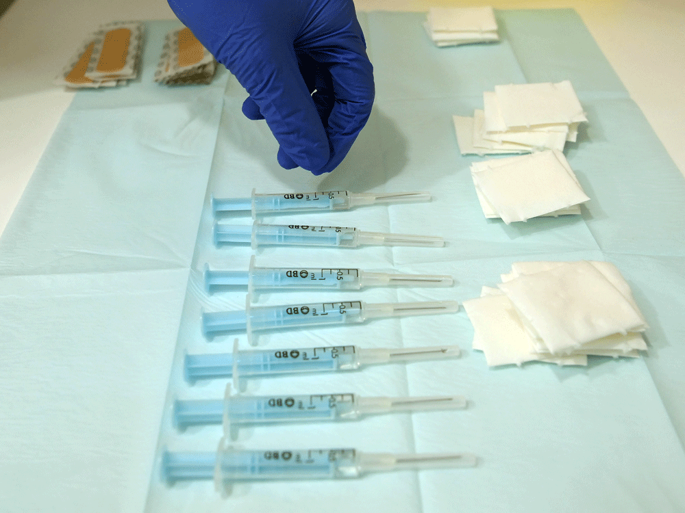File: A nurse picks a syringe containing a dose of the AstraZeneca's COVID-19 vaccine.