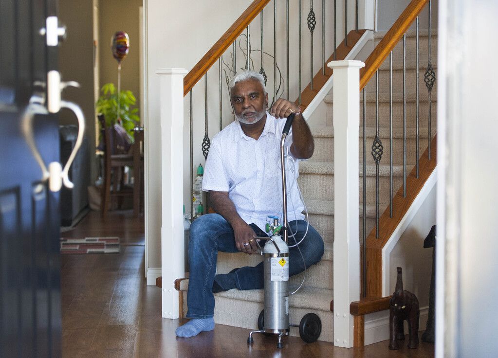 Atish Ram with an oxygen machine inside his Surrey home.