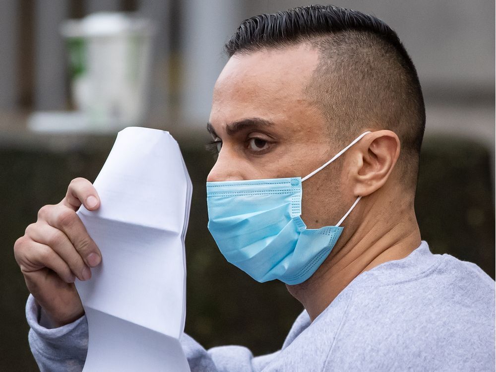 mohammad movassaghi with a copy of his release order as he leaves vancouver police department jail in vancouver on jan. 31, 2021.