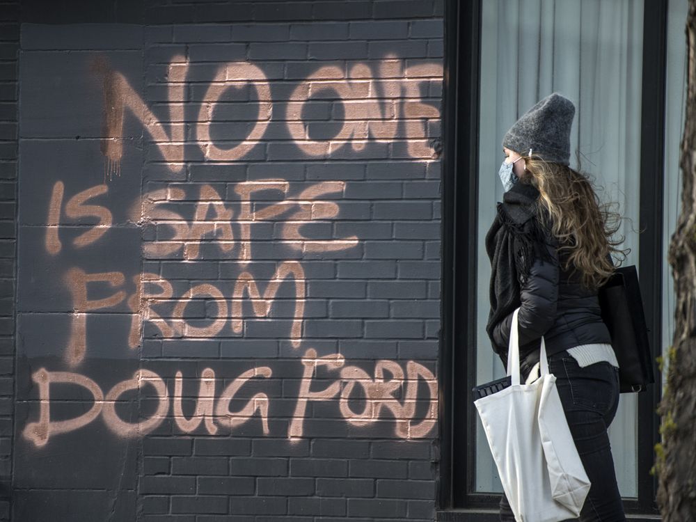 graffiti stating "no one is safe from doug ford" on toronto's dundas street west on april 21, 2021.