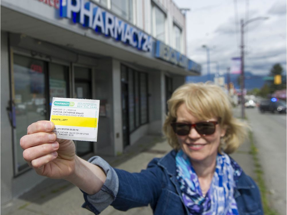 catherine hopkins outside pharmacy 24 on victoria drive in vancouver, bc tuesday, april 27, 2021 where she received her az vaccination against covid-19.