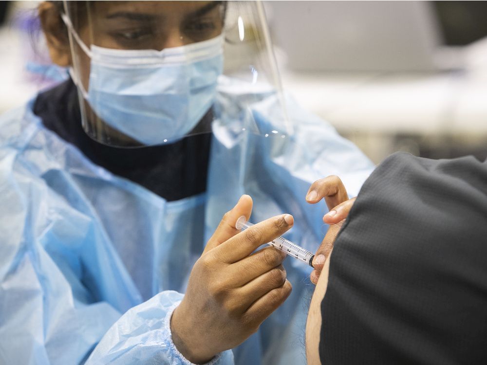 navpreet kaur administers a dose of the astrazeneca covid vaccine at the bill durnan arena in april.