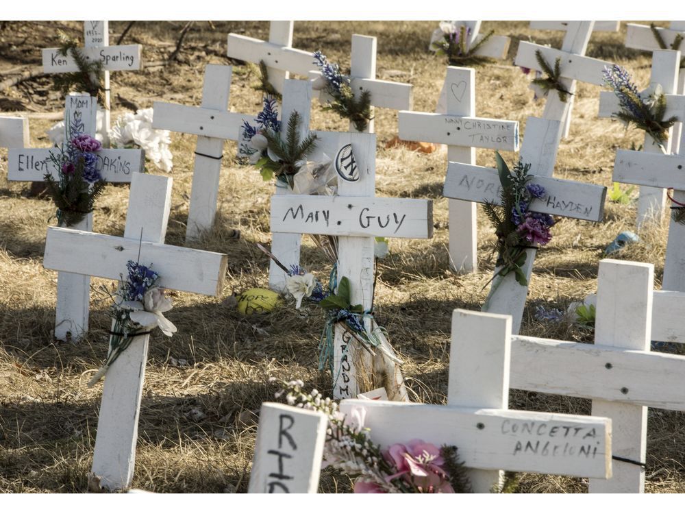 crosses of remembrance for loved ones lost to the covid-19 dot the lawn outside a long-term care home, on march 9, 2021.