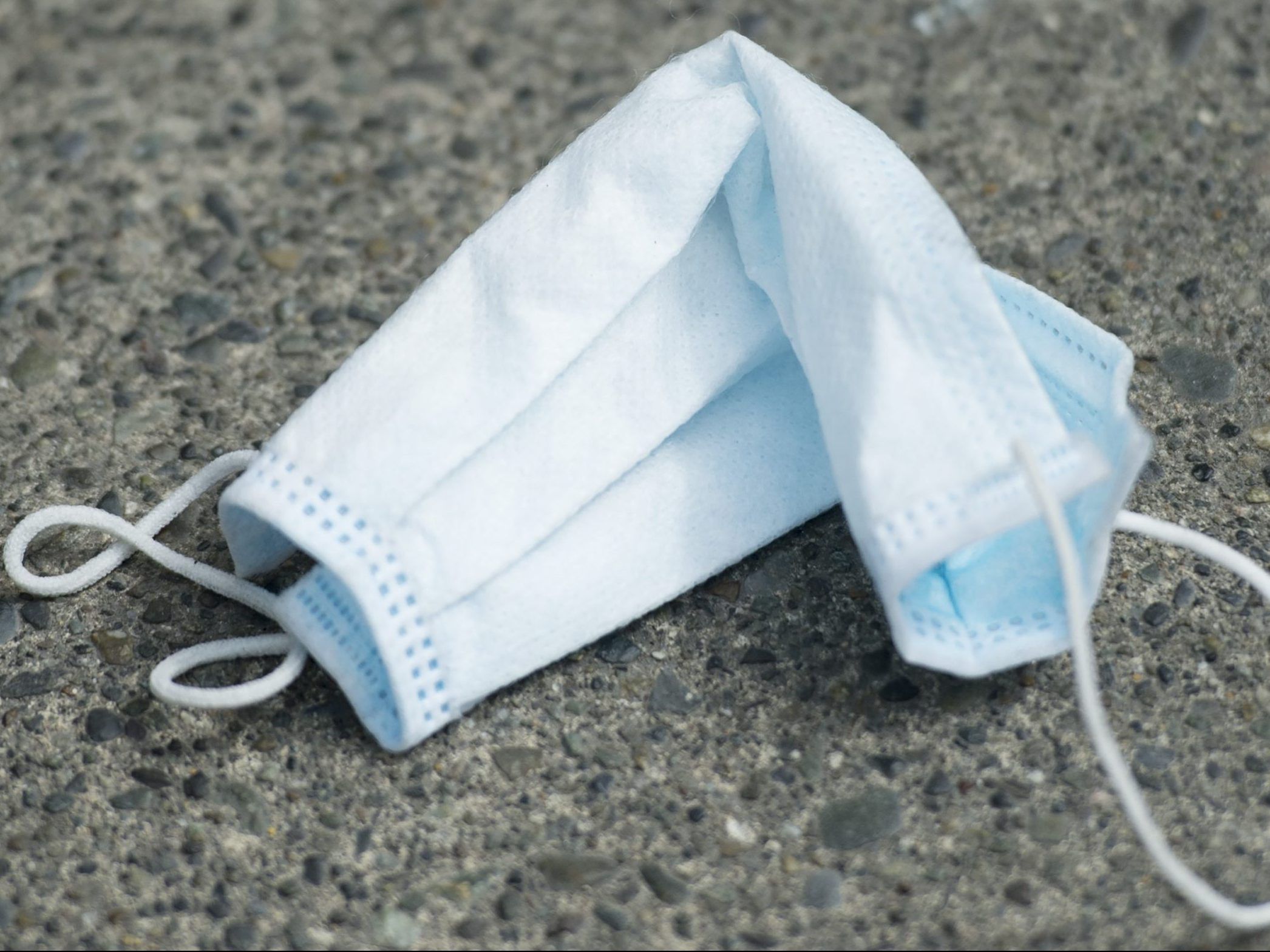 Discarded surgical mask can be seen on sidewalks and in gutters in downtown Vancouver as people throw away used protective masks and gloves.