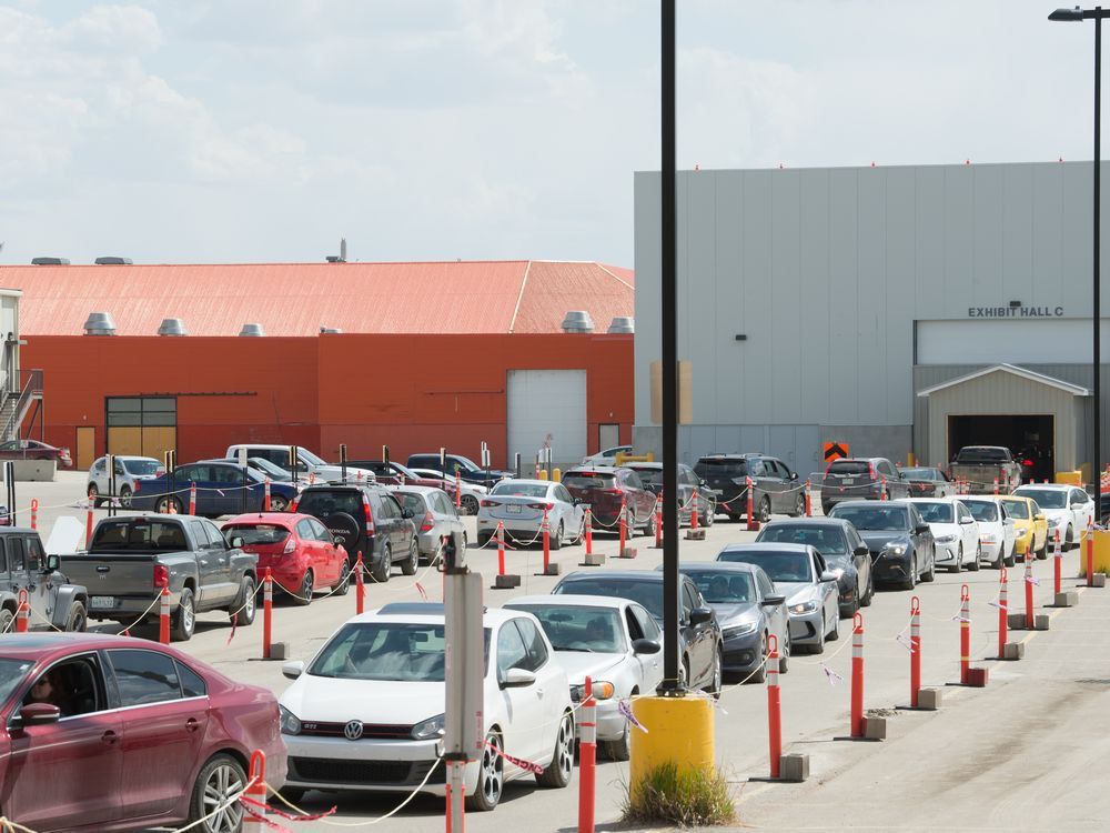 vehicles line up at a drive-thru covid-19 vaccine clinic at evraz place in regina, saskatchewan on may 14, 2021.