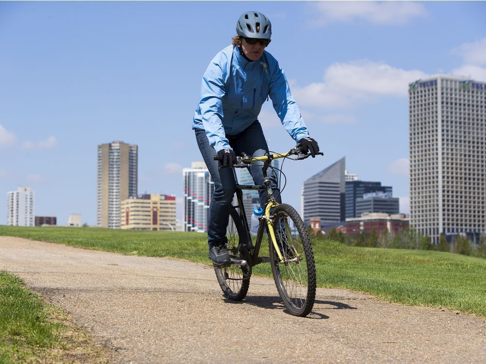 a cyclist races down a hill near the muttart conservatory on friday, may 21, 2021 in edmonton.