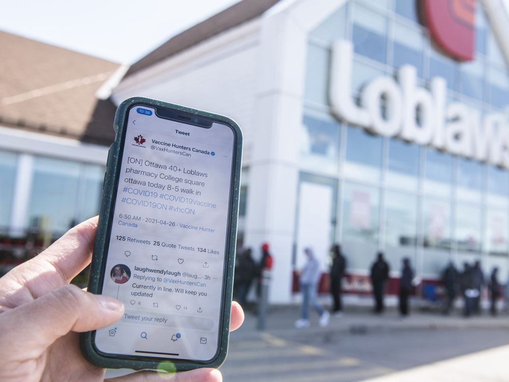 a post from twitter account vaccine hunters canada that shared details of a walk-in covid-19 vaccination clinic at a loblaws pharmacy in ottawa is seen on a mobile phone as people line up outside the store last month. people with disabilities can't quickly show up at a vaccine spot.