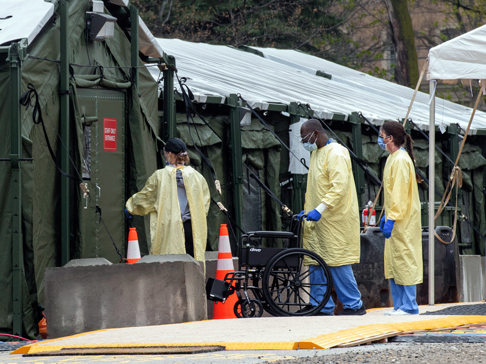 Staff enter the mobile field hospital set up to handle COVID-19 patients at Sunnybrook Hospital in Toronto. 