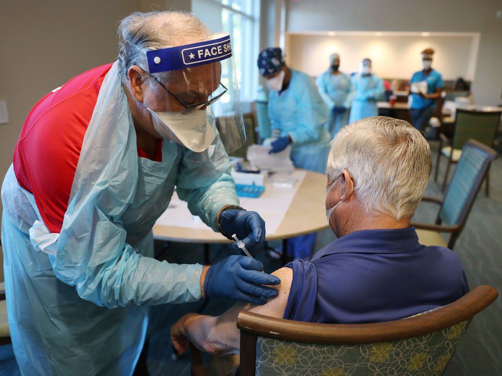 a healthcare worker with american medical response, inc working with the florida department of health in broward administers a pfizer-biontech covid-19 vaccine at the john knox village continuing care retirement community on january 6, 2021 in pompano beach, florida.