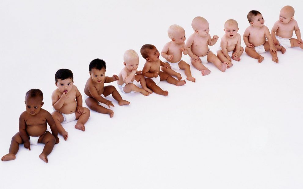 Row of babies (7-12 months) sitting on floor
