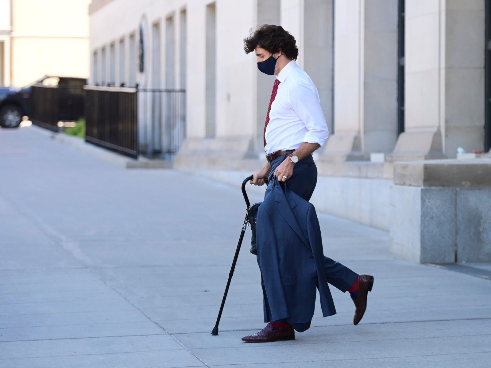 Prime Minister Justin Trudeau walks with a cane as he leaves a news conference in Ottawa on Monday, May 31, 2021.