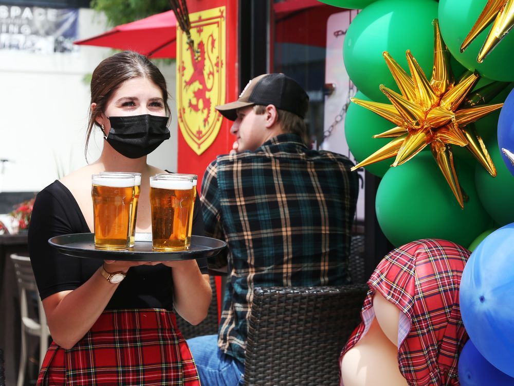 rachel sangster of deacon brodies public house on elgin street delivers cold beers on the patio, june 11, 2021.