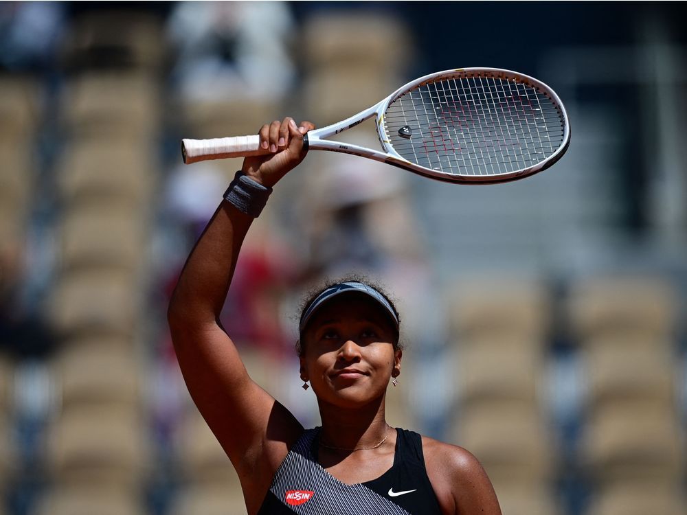 japan's naomi osaka celebrates after winning against romania's patricia maria tig during their women's singles first round tennis match on day 1 of the roland garros 2021 french open tennis tournament in paris on may 30, 2021.