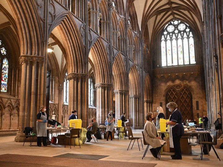  Members of the public receive a dose of the AstraZeneca/Oxford Covid-19 vaccine at Lichfield cathedral, which has been converted into a temporary vaccination centre, in Lichfield, central England on March 18, 2021.