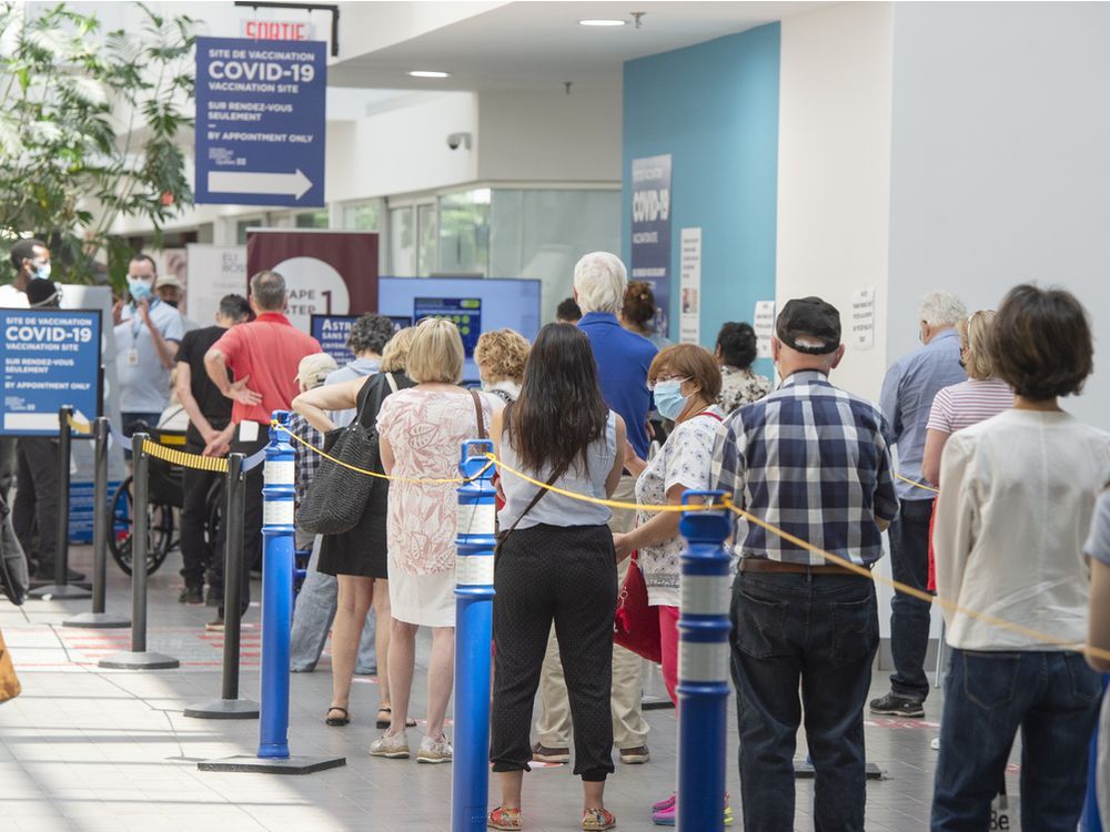 people line up to get their covid-19 vaccine on thursday. authorities are urging the public to remain patient during the ramp-up in vaccinations.