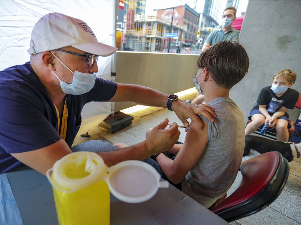 yann fraioli, 13, gets vaccinated by nurse el mahfoud mourouane during a walk-in vaccination clinic outside the bell centre prior to a canadiens playoff game last month.