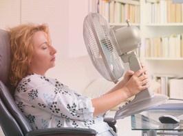 Woman in front of fan